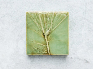 botanical tile with pine tree detail