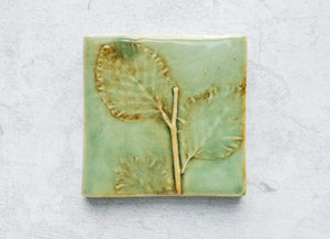 craftsman style botanical tile with tree leaf detail